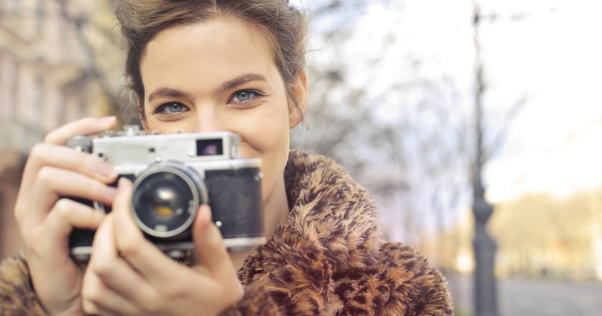 pretty girl holding a camera