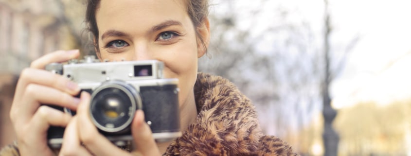 pretty girl holding a camera