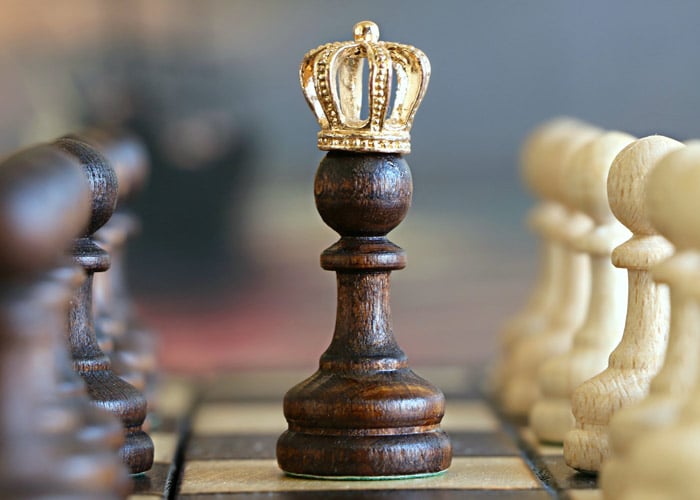 chess pieces with king in sharp focus