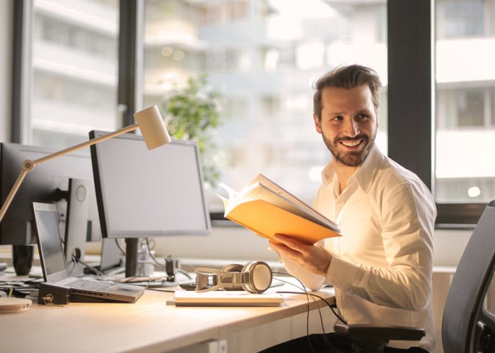 Young man at his desk in office